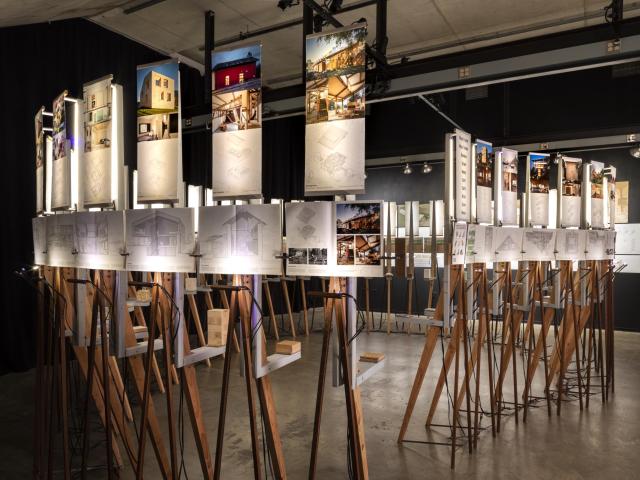 Biogenic House Section exhibition showing a circle of easels with books displayed on them  